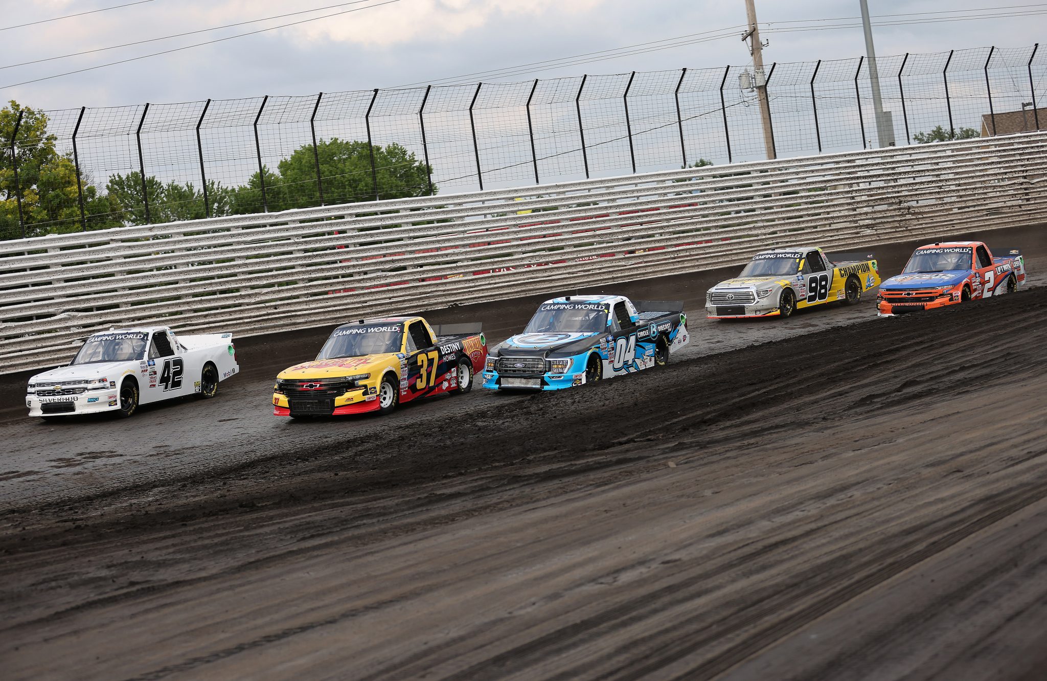 KNOXVILLE, IOWA - JULY 09: Carson Hocevar, driver of the #42 Premier Security Chevrolet, Brett Moffitt, driver of the #37 Concrete Supply/Destiny Homes Chevrolet, Chase Briscoe, driver of the #04 CircleBDiecast.com Ford, Grant Enfinger, driver of the #98 Champion/Curb Records Toyota, and Sheldon Creed, driver of the #2 Liftkits4less.com Chevrolet, race during qualifying for the NASCAR Camping World Truck Series Corn Belt 150 presented by Premier Chevy Dealers at Knoxville Raceway on July 09, 2021 in Knoxville, Iowa. (Photo by James Gilbert/Getty Images) | Getty Images