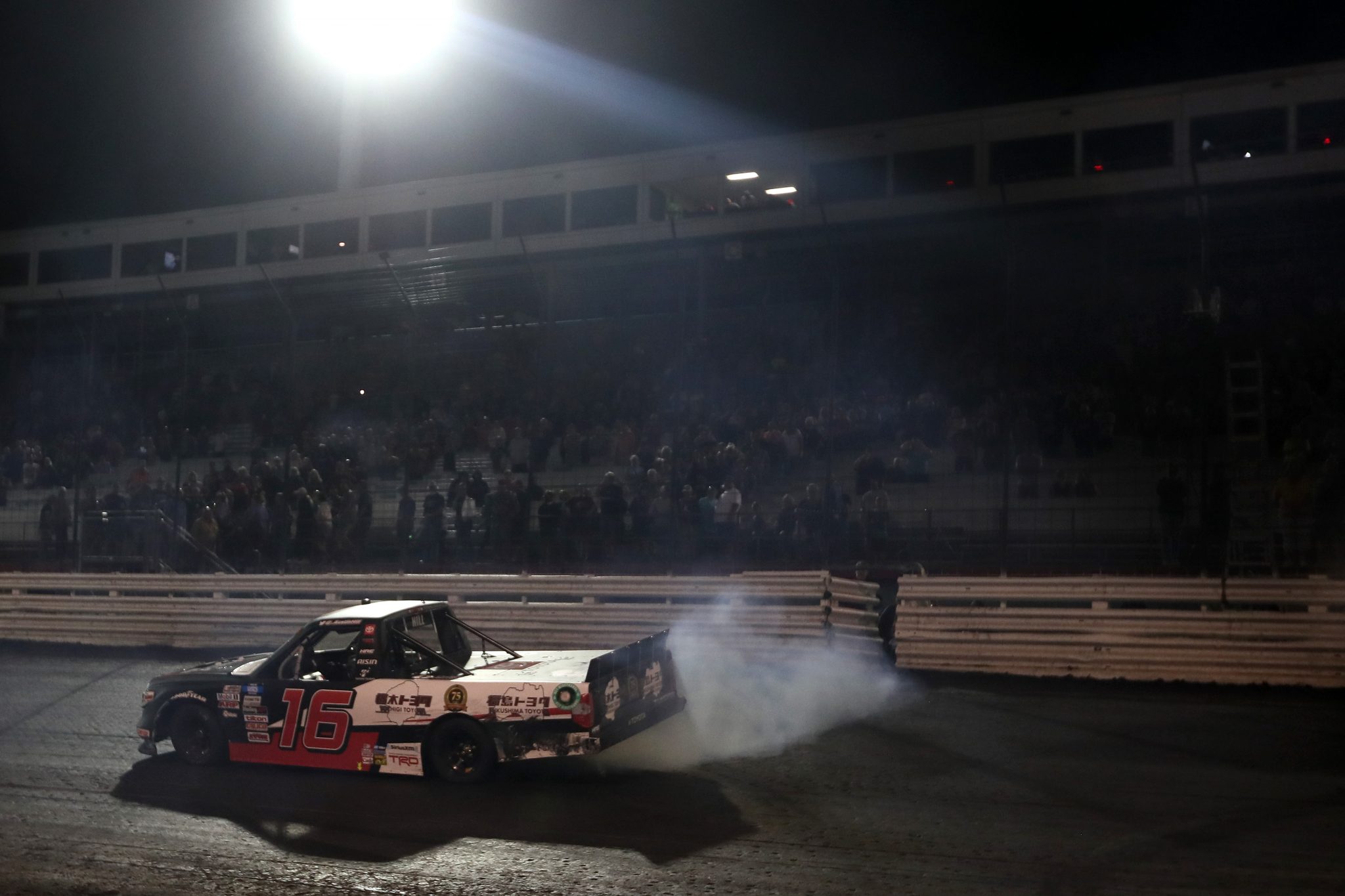 KNOXVILLE, IOWA - JULY 09: Austin Hill, driver of the #16 Toyota Mobility Parts/Tochigi/Fukishima Toyota, celebrates with a burnout after winning the NASCAR Camping World Truck Series Corn Belt 150 presented by Premier Chevy Dealers at Knoxville Raceway on July 09, 2021 in Knoxville, Iowa. (Photo by James Gilbert/Getty Images) | Getty Images