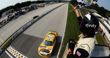 ELKHART LAKE, WISCONSIN - JULY 03: Kyle Busch, driver of the #54 M&M's Ice Cream Toyota, takes the checkered flag to win the NASCAR Xfinity Series Henry 180 at Road America on July 03, 2021 in Elkhart Lake, Wisconsin. (Photo by James Gilbert/Getty Images) | Getty Images