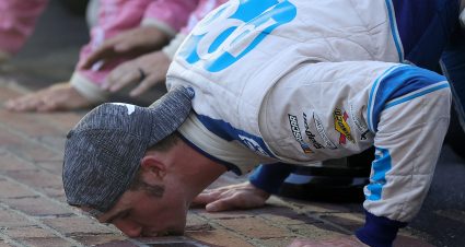 INDIANAPOLIS, INDIANA - AUGUST 14: Austin Cindric, driver of the #22 PPG Ford, celebrate by kissing the bricks after winning the NASCAR Xfinity Series Pennzoil 150 at the Brickyard at Indianapolis Motor Speedway on August 14, 2021 in Indianapolis, Indiana. (Photo by Stacy Revere/Getty Images) | Getty Images