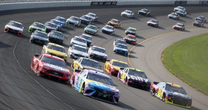 BROOKLYN, MICHIGAN - AUGUST 09: Kyle Busch, driver of the #18 M&M's Fudge Brownie Toyota, races Kevin Harvick, driver of the #4 Busch Light Apple Ford, and William Byron, driver of the #24 Axalta Chevrolet, during the NASCAR Cup Series Consumers Energy 400 at Michigan International Speedway on August 09, 2020 in Brooklyn, Michigan. (Photo by Brian Lawdermilk/Getty Images) | Getty Images