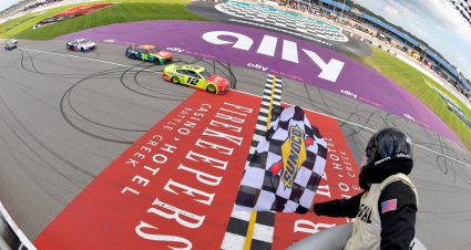 BROOKLYN, MICHIGAN - AUGUST 22: Ryan Blaney, driver of the #12 Menards/Cardell Cabinetry Ford,takes the checkered flag to win  the NASCAR Cup Series FireKeepers Casino 400 at Michigan International Speedway on August 22, 2021 in Brooklyn, Michigan. (Photo by Logan Riely/Getty Images) | Getty Images