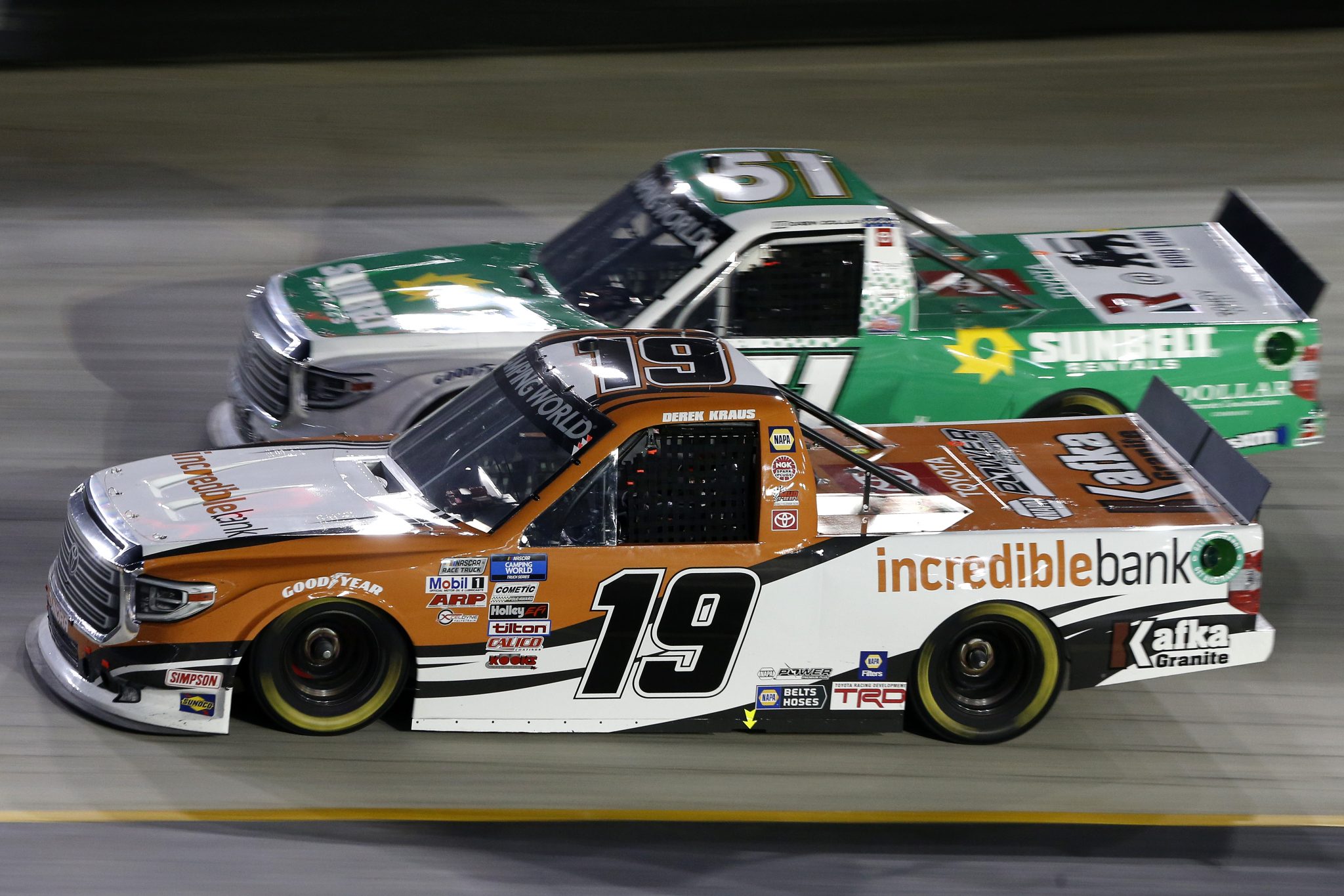 BRISTOL, TENNESSEE - SEPTEMBER 16: Derek Kraus, driver of the #19 Incredible Bank Toyota, and Drew Dollar, driver of the #51 Sunbelt Rentals Toyota, race during the NASCAR Camping World Truck Series UNOH 200 presented by Ohio Logistics at Bristol Motor Speedway on September 16, 2021 in Bristol, Tennessee. (Photo by Brian Lawdermilk/Getty Images) | Getty Images