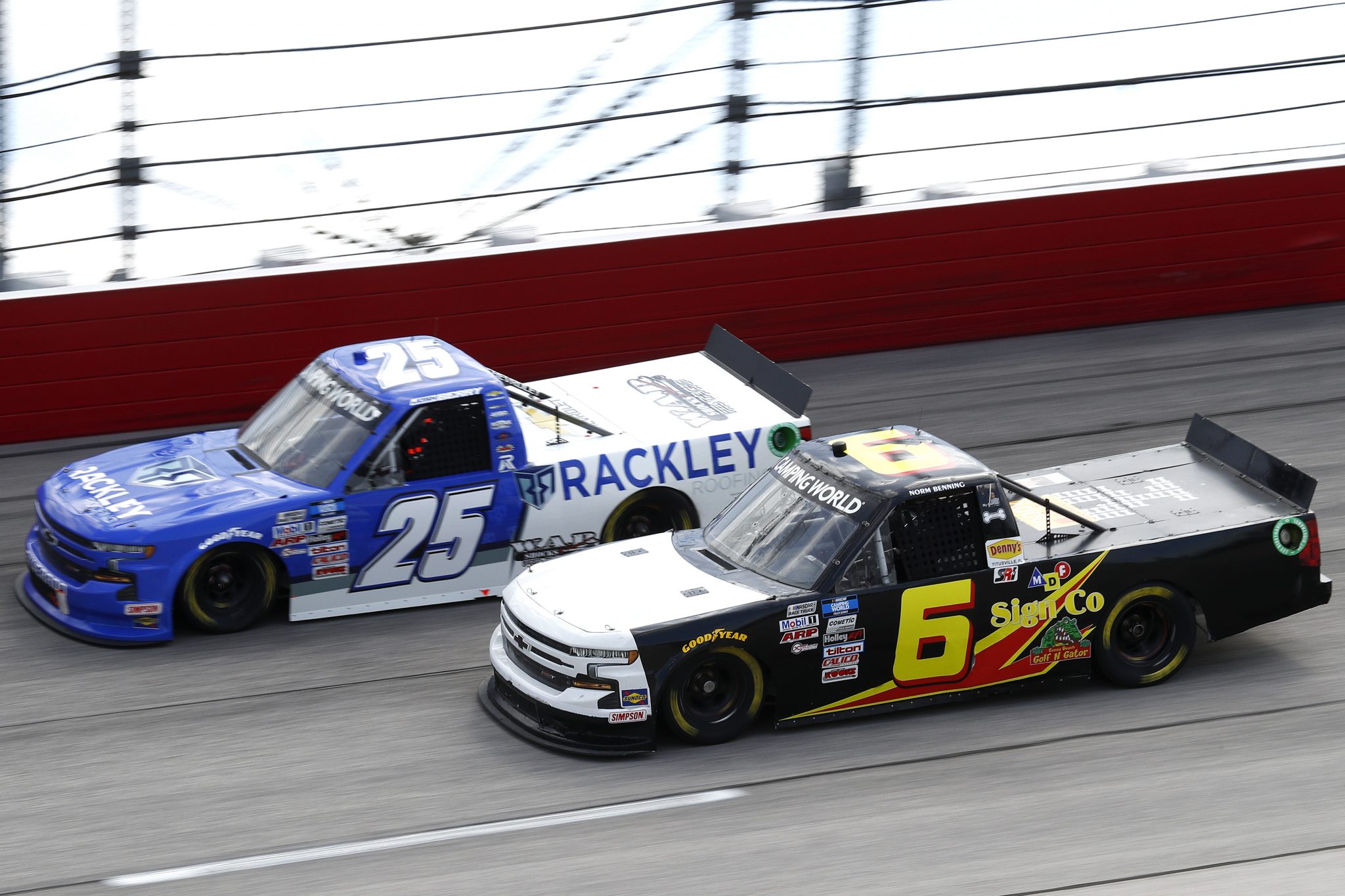 DARLINGTON, SOUTH CAROLINA - SEPTEMBER 05: Josh Berry, driver of the #25 Rackley Roofing Chevrolet, and Norm Benning, driver of the #6 MDS A Sign Co Chevrolet, race during the NASCAR Camping World Truck Series In It To Win It 200 at Darlington Raceway on September 05, 2021 in Darlington, South Carolina. (Photo by Jared East/Getty Images) | Getty Images