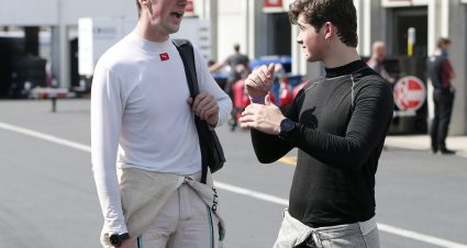 CHARLOTTE, NORTH CAROLINA - SEPTEMBER 27: Austin Cindric, driver of the #22 MoneyLion Ford, talks with Harrison Burton, driver of the #18 DEX Imaging Toyota, during practice for the NASCAR Xfinity Series Drive for the Cure 250 presented by Blue Cross Blue Shield of North Carolina at Charlotte Motor Speedway on September 27, 2019 in Charlotte, North Carolina. (Photo by Brian Lawdermilk/Getty Images) | Getty Images