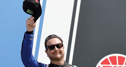 LOUDON, NEW HAMPSHIRE - JULY 17: Kurt Busch, driver of the #45 SiriusXM Radio Toyota, waves to fans as he walks onstage during driver intros prior to the NASCAR Cup Series Ambetter 301 at New Hampshire Motor Speedway on July 17, 2022 in Loudon, New Hampshire. (Photo by Tim Nwachukwu/Getty Images) | Getty Images