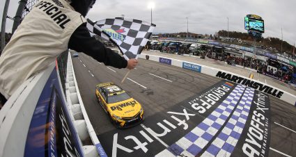 MARTINSVILLE, VIRGINIA - OCTOBER 30: Christopher Bell, driver of the #20 DeWalt Toyota, takes the checkered flag to win the NASCAR Cup Series Xfinity 500 at Martinsville Speedway on October 30, 2022 in Martinsville, Virginia. (Photo by Mike Mulholland/Getty Images) | Getty Images