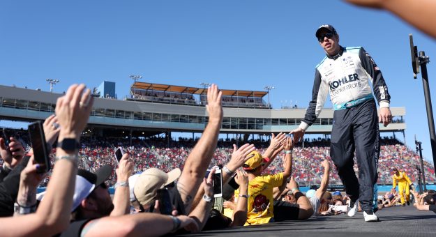 AVONDALE, ARIZONA - NOVEMBER 06: Brad Keselowski, driver of the #6 Kohler Generators Ford, greets fans as he walks onstage during driver intros prior to  the NASCAR Cup Series Championship at Phoenix Raceway on November 06, 2022 in Avondale, Arizona. (Photo by Christian Petersen/Getty Images) | Getty Images