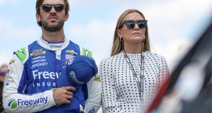 INDIANAPOLIS, INDIANA - JULY 31: Daniel Suarez, driver of the #99 Freeway Insurance Chevrolet,  and Julia Piquet stand on the grid during pre-race ceremonies prior to the NASCAR Cup Series Verizon 200 at the Brickyard at Indianapolis Motor Speedway on July 31, 2022 in Indianapolis, Indiana. (Photo by James Gilbert/Getty Images) | Getty Images