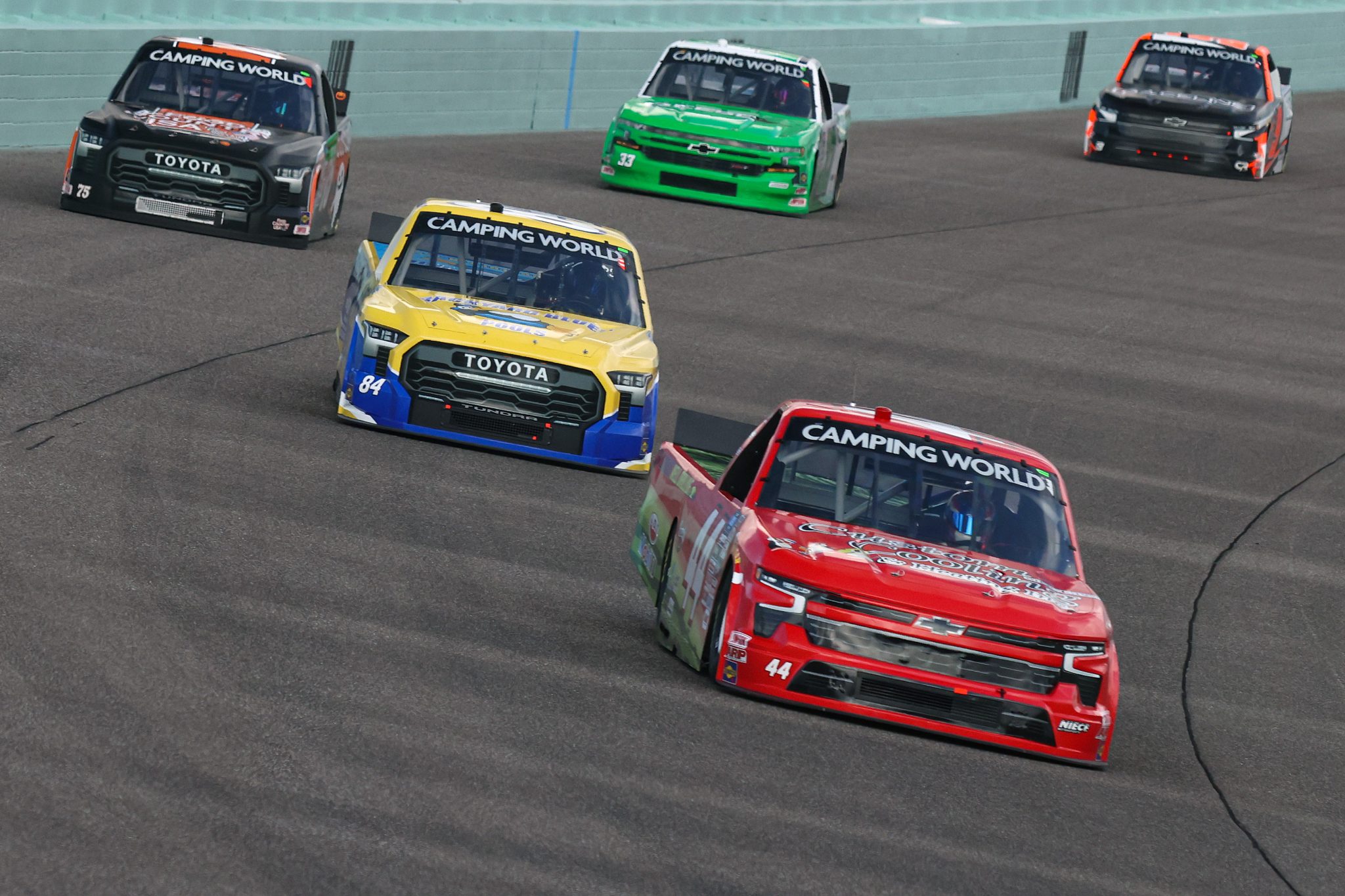 HOMESTEAD, FLORIDA - OCTOBER 21: Chad Chastain, driver of the #44 Custom Cooling & Heating Inc. Chevrolet, Clay Greenfield, driver of the #84 Backyard Blues Pools Toyota, and Parker Kligerman, driver of the #75 Food Country USA Toyota, drive during practice for the NASCAR Camping World Truck Series Baptist Health 200 at Homestead-Miami Speedway on October 21, 2022 in Homestead, Florida. (Photo by Jared East/Getty Images) | Getty Images