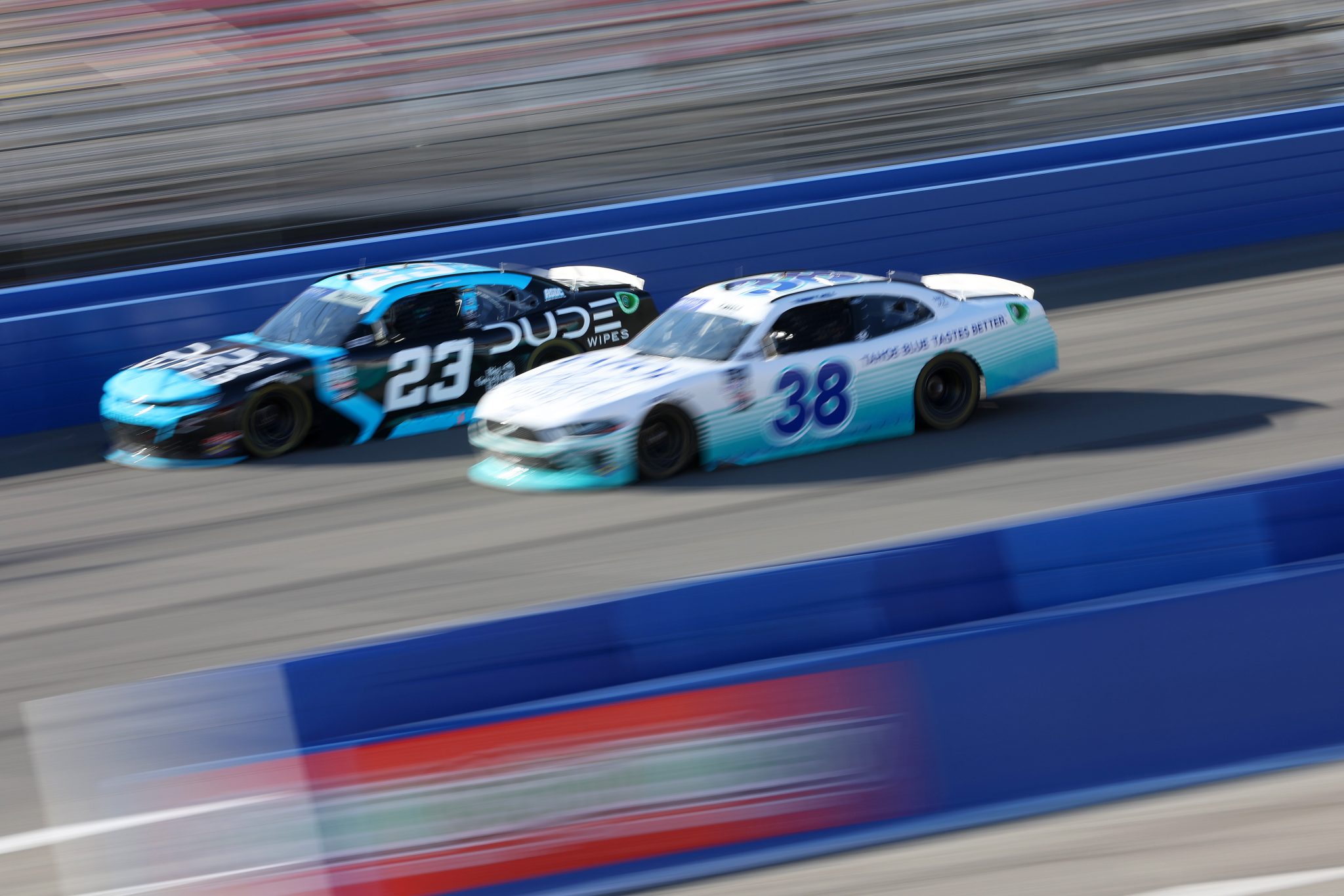 FONTANA, CALIFORNIA - FEBRUARY 26: Anthony Alfredo, driver of the #23 Dude Wipes Chevrolet, and Timmy Hill, driver of the #38 Tahoe Blue Vodka Ford, drive during practice for the NASCAR Xfinity Series Production Alliance 300 at Auto Club Speedway on February 26, 2022 in Fontana, California. (Photo by James Gilbert/Getty Images) | Getty Images