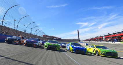 FONTANA, CALIFORNIA - FEBRUARY 27: Austin Cindric, driver of the #2 Menards/Quaker State Ford, leads Daniel Hemric, driver of the #16 Poppy Bank Chevrolet, Denny Hamlin, driver of the #11 FedEx Ground Toyota, Kyle Busch, driver of the #18 Interstate Batteries Toyota, and Erik Jones, driver of the #43 FOCUS factor Chevrolet, in a five-wide salute the fans prior to the NASCAR Cup Series Wise Power 400 at Auto Club Speedway on February 27, 2022 in Fontana, California. (Photo by James Gilbert/Getty Images) | Getty Images
