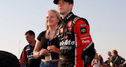 LEBANON, TENNESSEE - JUNE 18: Chandler Smith, driver of the #18 Safelite AutoGlass Toyota, and fiancé Kenzie Grams wait on the NASCAR Camping World Truck Series Rackley Roofing 200 at Nashville Superspeedway on June 18, 2021 in Lebanon, Tennessee. (Photo by Sarah Stier/Getty Images) | Getty Images