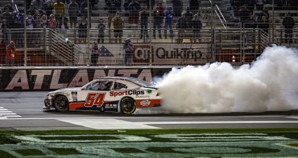 HAMPTON, GEORGIA - MARCH 19: Ty Gibbs, driver of the #54 Sport Clips Haircuts Toyota, celebrates with a burnout after winning the NASCAR Xfinity Series Nalley Cars 250 at Atlanta Motor Speedway on March 19, 2022 in Hampton, Georgia. (Photo by Sean Gardner/Getty Images) | Getty Images