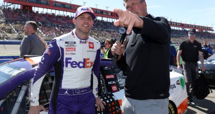 FONTANA, CALIFORNIA - FEBRUARY 27: Denny Hamlin, driver of the #11 FedEx Ground Toyota, (L)  and NASCAR Fox Sports broadcasters Michael Waltrip talk on the grid prior to the NASCAR Cup Series Wise Power 400 at Auto Club Speedway on February 27, 2022 in Fontana, California. (Photo by James Gilbert/Getty Images) | Getty Images