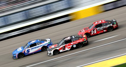 LAS VEGAS, NEVADA - MARCH 06: Kyle Larson, driver of the #5 HendrickCars.com Chevrolet, Kevin Harvick, driver of the #4 Rheem Smurfit Kappa Ford, and Chase Briscoe, driver of the #14 Mahindra Tractors Ford, race during the NASCAR Cup Series Pennzoil 400 at Las Vegas Motor Speedway on March 06, 2022 in Las Vegas, Nevada. (Photo by Meg Oliphant/Getty Images) | Getty Images