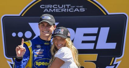 AUSTIN, TEXAS - MARCH 26: Zane Smith, driver of the #38 Speedco Ford, poses for a photo with his girlfriend, McCall Gaulding  in victory lane after winning the NASCAR Camping World Truck Series - XPEL 225 at Circuit of The Americas on March 26, 2022 in Austin, Texas. (Photo by Logan Riely/Getty Images) | Getty Images