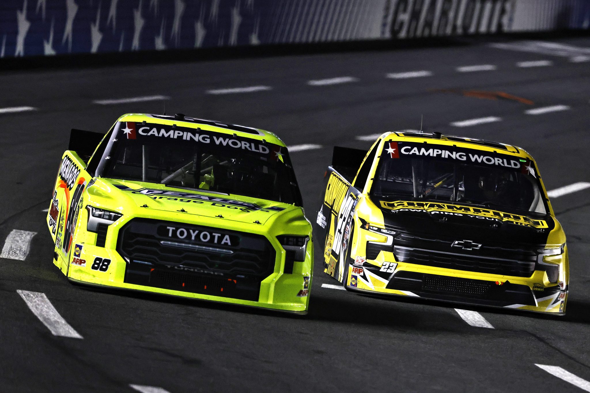 CONCORD, NORTH CAROLINA - MAY 27: Matt Crafton, driver of the #88 Ideal Door/Menards Toyota, and Grant Enfinger, driver of the #23 Champion Power Equipment Chevrolet, race during the NASCAR Camping World Truck Series North Carolina Education Lottery 200 at Charlotte Motor Speedway on May 27, 2022 in Concord, North Carolina. (Photo by Buda Mendes/Getty Images) | Getty Images