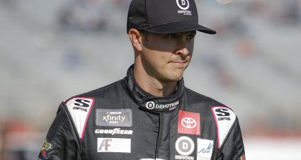 HAMPTON, GEORGIA - MARCH 19: Trevor Bayne, driver of the #18 Devotion Nutrition Toyota, walks the grid prior to the NASCAR Xfinity Series Nalley Cars 250 at Atlanta Motor Speedway on March 19, 2022 in Hampton, Georgia. (Photo by Sean Gardner/Getty Images) | Getty Images