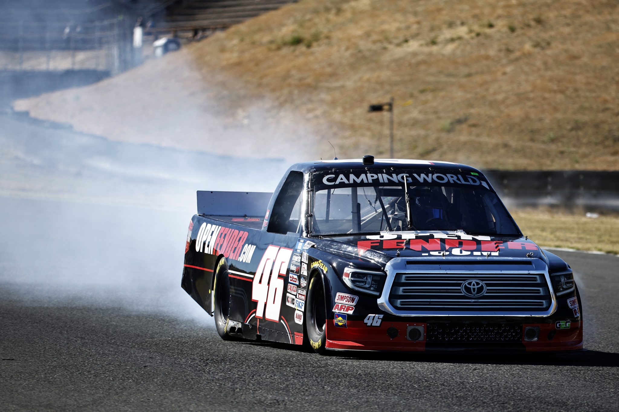 SONOMA, CALIFORNIA - JUNE 11: Mason Filippi, driver of the #46 OpenFender.com Toyota, drives with a trail of smoke during the NASCAR Camping World Truck Series DoorDash 250 at Sonoma Raceway on June 11, 2022 in Sonoma, California. (Photo by Chris Graythen/Getty Images) | Getty Images