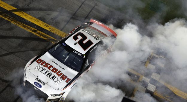 DAYTONA BEACH, FLORIDA - FEBRUARY 20: Austin Cindric, driver of the #2 Discount Tire Ford, celebrates with a burnout after winning the NASCAR Cup Series 64th Annual Daytona 500 at Daytona International Speedway on February 20, 2022 in Daytona Beach, Florida. (Photo by Sean Gardner/Getty Images) | Getty Images
