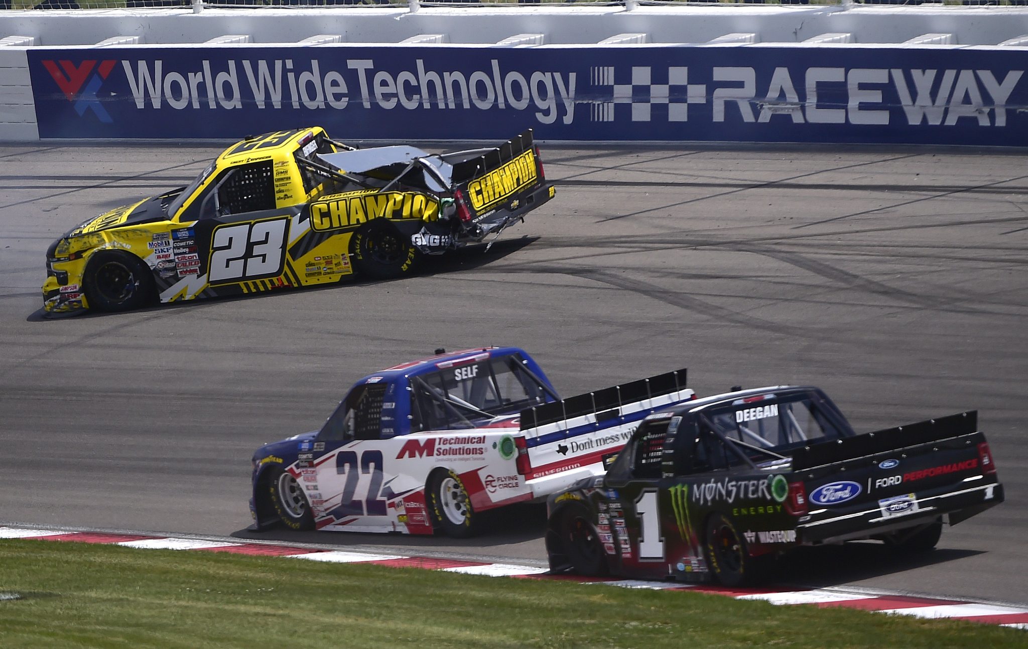MADISON, ILLINOIS - JUNE 04: Grant Enfinger, driver of the #23 Champion Power Equipment Chevrolet, spins after an on-track incident as Austin Wayne Self, driver of the #22 AM Technical Solutions Chevrolet, and Hailie Deegan, driver of the #1 Monster Energy Ford, pass during the NASCAR Camping World Truck Series Toyota 200 at WWT Raceway on June 04, 2022 in Madison, Illinois. (Photo by Jeff Curry/Getty Images) | Getty Images
