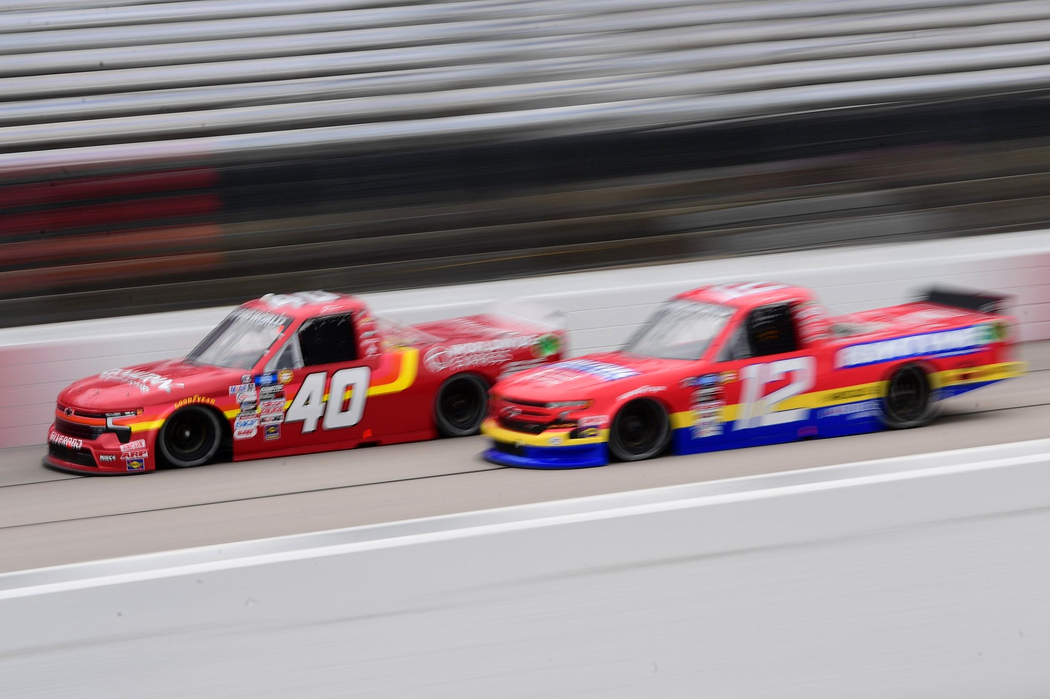 DARLINGTON, SOUTH CAROLINA - MAY 06: Dean Thompson, driver of the #40 Worldwide Express Chevrolet, and Spencer Boyd, driver of the #12 Rimtyme Chevrolet, drive during practice for the NASCAR Camping World Truck Series Dead on Tools 200 at Darlington Raceway on May 06, 2022 in Darlington, South Carolina. (Photo by Emilee Chinn/Getty Images) | Getty Images