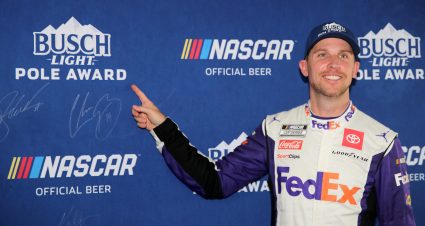 LEBANON, TENNESSEE - JUNE 25: Denny Hamlin, driver of the #11 FedEx Office Toyota, points to his signature on the Busch Light Pole Award backdrop after winning the pole award for the NASCAR Cup Series Ally 400 at Nashville Superspeedway on June 25, 2022 in Lebanon, Tennessee. (Photo by Meg Oliphant/Getty Images) | Getty Images
