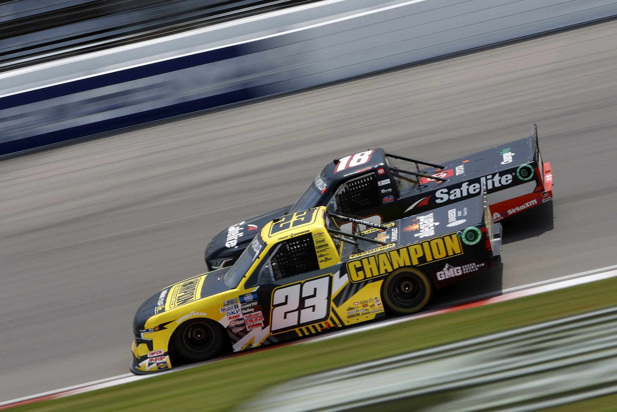 MADISON, ILLINOIS - JUNE 04: Grant Enfinger, driver of the #23 Champion Power Equipment Chevrolet, and Chandler Smith, driver of the #18 Safelite AutoGlass Toyota, race during the NASCAR Camping World Truck Series Toyota 200 at WWT Raceway on June 04, 2022 in Madison, Illinois. (Photo by Sean Gardner/Getty Images) | Getty Images