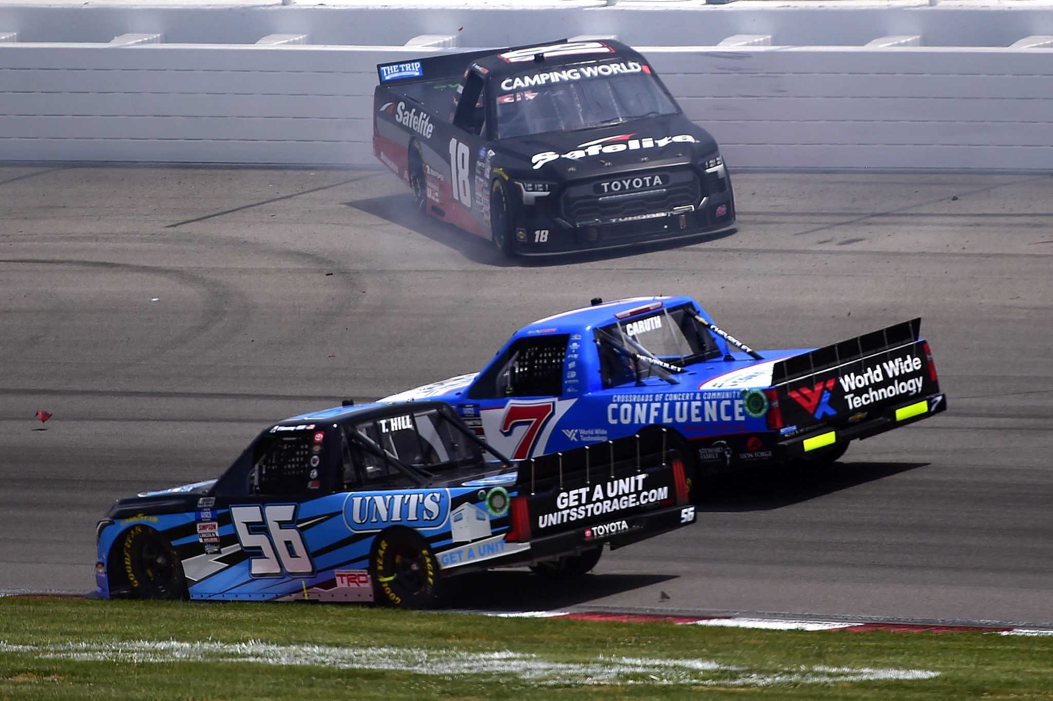 MADISON, ILLINOIS - JUNE 04: Chandler Smith, driver of the #18 Safelite AutoGlass Toyota, spins after an on-track incident as Timmy Hill, driver of the #56 UNITS Storage Toyota, and Rajah Caruth, driver of the #7 Confluence Music Festival Chevrolet, pass during the NASCAR Camping World Truck Series Toyota 200 at WWT Raceway on June 04, 2022 in Madison, Illinois. (Photo by Jeff Curry/Getty Images) | Getty Images