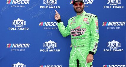 LOUDON, NEW HAMPSHIRE - JULY 16: Martin Truex Jr., driver of the #19 Interstate Batteries Toyota, points to his signature on the Busch Light Pole Award backdrop after winning the pole award for the NASCAR Cup Series Ambetter 301 at New Hampshire Motor Speedway on July 16, 2022 in Loudon, New Hampshire. (Photo by James Gilbert/Getty Images) | Getty Images
