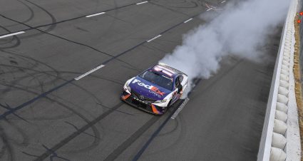 LONG POND, PENNSYLVANIA - JULY 24: Denny Hamlin, driver of the #11 FedEx Office Toyota, celebrates with a burnout after winning the NASCAR Cup Series M&M's Fan Appreciation 400 at Pocono Raceway on July 24, 2022 in Long Pond, Pennsylvania. (Photo by Logan Riely/Getty Images) | Getty Images