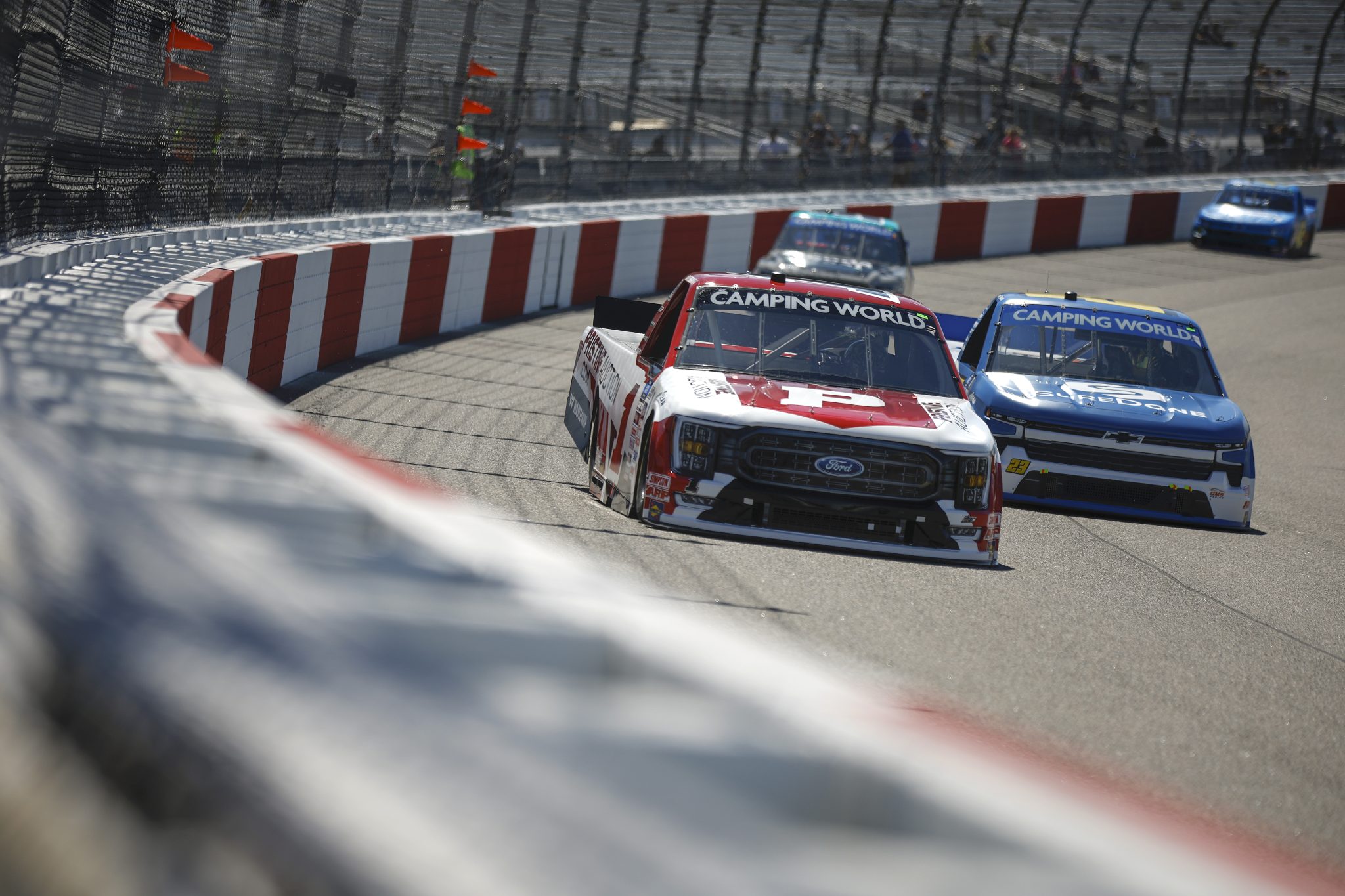 RICHMOND, VIRGINIA - AUGUST 13: Hailie Deegan, driver of the #1 Pristine Auction Ford, and Grant Enfinger, driver of the #23 Suredone Chevrolet, drive during practice for the NASCAR Camping World Truck Series Worldwide Express 250 for Carrier Appreciation at Richmond Raceway on August 13, 2022 in Richmond, Virginia. (Photo by Jared C. Tilton/Getty Images) | Getty Images