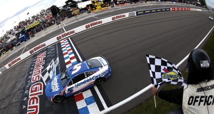 WATKINS GLEN, NEW YORK - AUGUST 21: Kyle Larson, driver of the #5 HendrickCars.com Chevrolet, takes the checkered flag to win the NASCAR Cup Series Go Bowling at The Glen at Watkins Glen International on August 21, 2022 in Watkins Glen, New York. (Photo by Sean Gardner/Getty Images) | Getty Images