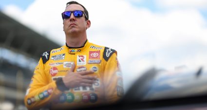 INDIANAPOLIS, INDIANA - JULY 31: Kyle Busch, driver of the #18 M&M's Peanut Butter Toyota, stands on the grid during pre-race ceremonies prior to the NASCAR Cup Series Verizon 200 at the Brickyard at Indianapolis Motor Speedway on July 31, 2022 in Indianapolis, Indiana. (Photo by James Gilbert/Getty Images) | Getty Images