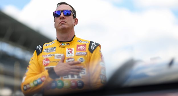 INDIANAPOLIS, INDIANA - JULY 31: Kyle Busch, driver of the #18 M&M's Peanut Butter Toyota, stands on the grid during pre-race ceremonies prior to the NASCAR Cup Series Verizon 200 at the Brickyard at Indianapolis Motor Speedway on July 31, 2022 in Indianapolis, Indiana. (Photo by James Gilbert/Getty Images) | Getty Images