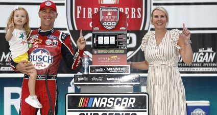 BROOKLYN, MICHIGAN - AUGUST 07: Kevin Harvick, driver of the #4 Busch Light Apple #BuschelOfBusch Ford, celebrates with his wife, DeLana Harvick and daughter, Piper in victory lane after winning the NASCAR Cup Series FireKeepers Casino 400 at Michigan International Speedway on August 07, 2022 in Brooklyn, Michigan. (Photo by Sean Gardner/Getty Images) | Getty Images