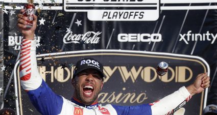 KANSAS CITY, KANSAS - SEPTEMBER 11: Bubba Wallace, driver of the #45 ROOT Insurance Toyota, celebrates in victory lane after winning the NASCAR Cup Series Hollywood Casino 400 at Kansas Speedway on September 11, 2022 in Kansas City, Kansas. (Photo by Chris Graythen/Getty Images) | Getty Images
