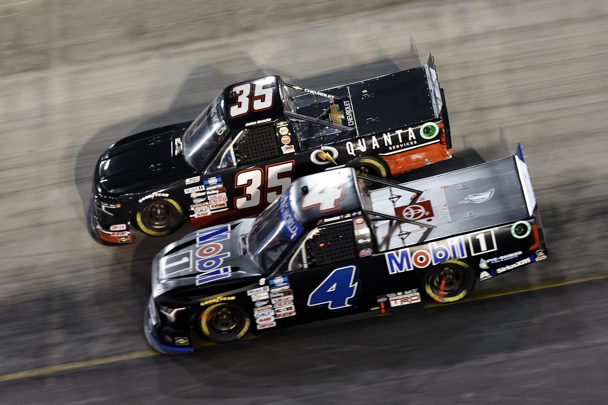 BRISTOL, TENNESSEE - SEPTEMBER 15: John Hunter Nemechek, driver of the #4 Pye-Barker Fire & Safety Toyota, and Jake Garcia, driver of the #35 Quanta Services Chevrolet, race during the NASCAR Camping World Truck Series UNOH 200 at Bristol Motor Speedway on September 15, 2022 in Bristol, Tennessee. (Photo by Sean Gardner/Getty Images) | Getty Images