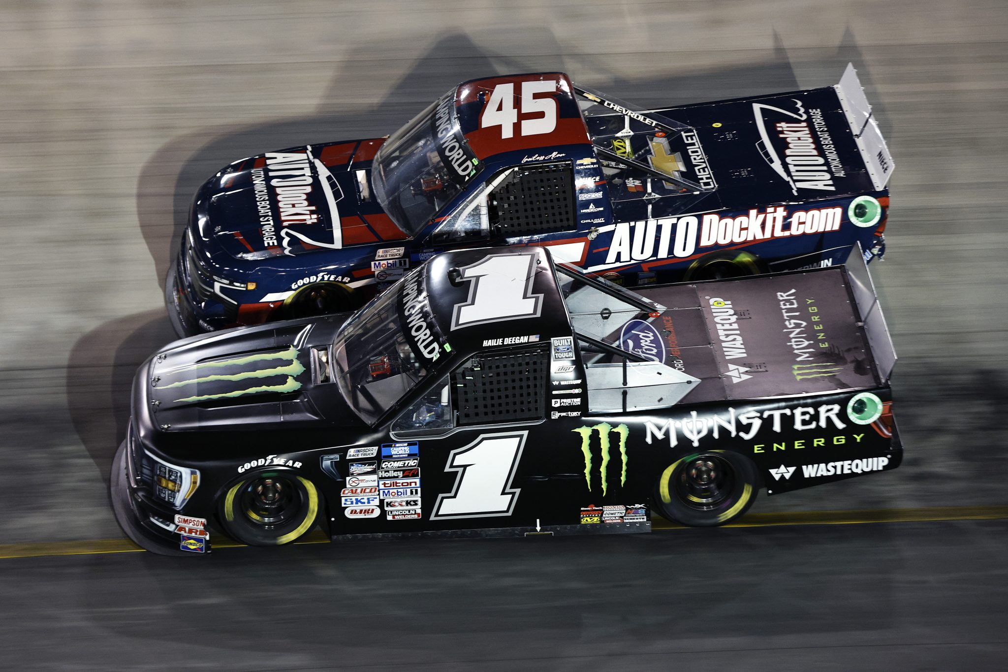 BRISTOL, TENNESSEE - SEPTEMBER 15: Hailie Deegan, driver of the #1 Monster Energy Ford, and Lawless Alan, driver of the #45 AUTODockit Chevrolet, race during the NASCAR Camping World Truck Series UNOH 200 at Bristol Motor Speedway on September 15, 2022 in Bristol, Tennessee. (Photo by Sean Gardner/Getty Images) | Getty Images