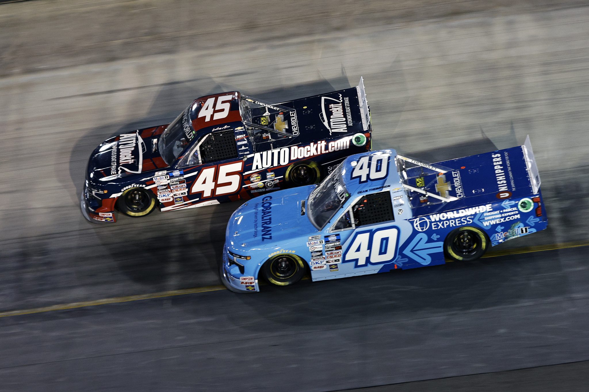 BRISTOL, TENNESSEE - SEPTEMBER 15: Lawless Alan, driver of the #45 AUTODockit Chevrolet, and Dean Thompson, driver of the #40 Worldwide Express Chevrolet, race during the NASCAR Camping World Truck Series UNOH 200 at Bristol Motor Speedway on September 15, 2022 in Bristol, Tennessee. (Photo by Sean Gardner/Getty Images) | Getty Images