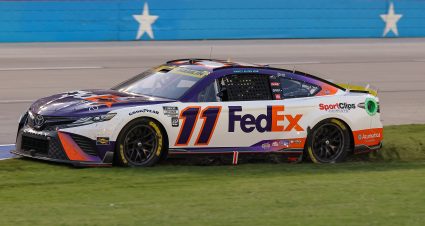 FORT WORTH, TEXAS - SEPTEMBER 25: Denny Hamlin, driver of the #11 FedEx Office Toyota, spins into the infield grass  at Texas Motor Speedway on September 25, 2022 in Fort Worth, Texas. (Photo by Jonathan Bachman/Getty Images) | Getty Images