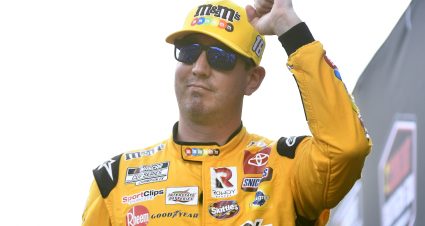 DARLINGTON, SOUTH CAROLINA - SEPTEMBER 04: Kyle Busch, driver of the #18 M&M's Toyota, aves to fans as he walks onstage during driver intros prior to the NASCAR Cup Series Cook Out Southern 500 at Darlington Raceway on September 04, 2022 in Darlington, South Carolina. (Photo by Logan Riely/Getty Images) | Getty Images