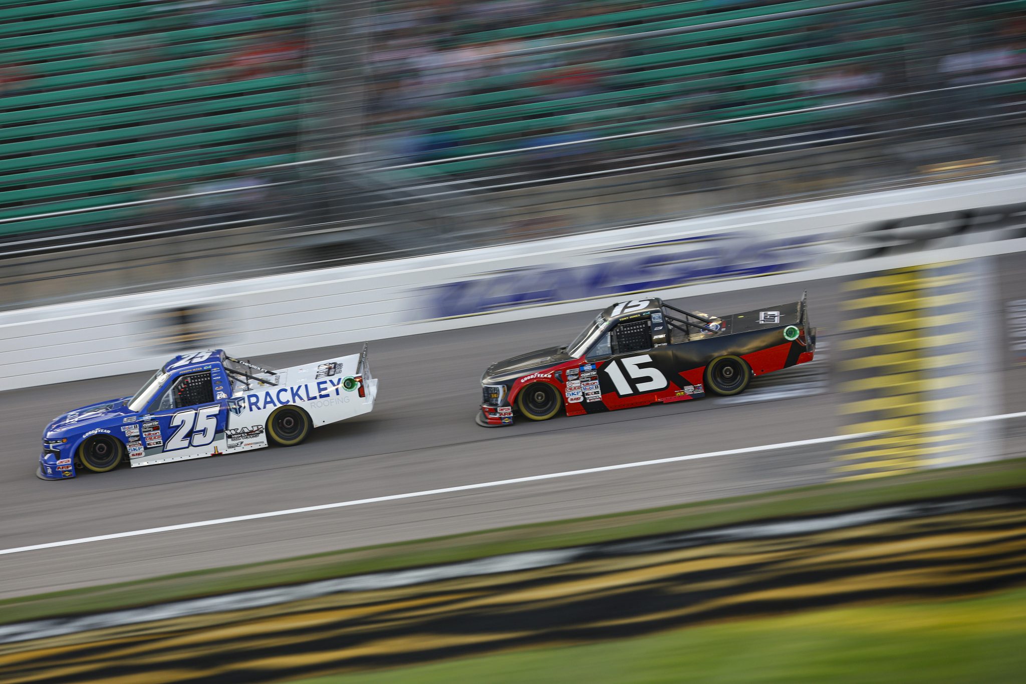 KANSAS CITY, KANSAS - SEPTEMBER 09: Matt Dibenedetto, driver of the #25 Rackley Roofing Chevrolet, and Tanner Gray, driver of the #15 Ford Performance Ford, race during the NASCAR Camping World Truck Series Kansas Lottery 200 at Kansas Speedway on September 09, 2022 in Kansas City, Kansas. (Photo by Chris Graythen/Getty Images) | Getty Images