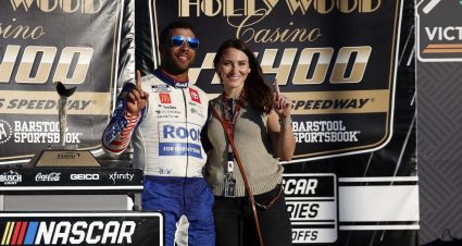 KANSAS CITY, KANSAS - SEPTEMBER 11: Bubba Wallace, driver of the #45 ROOT Insurance Toyota, celebrates with fiance, Amanda Carter and pet dog, Asher in victory lane after winning the NASCAR Cup Series Hollywood Casino 400 at Kansas Speedway on September 11, 2022 in Kansas City, Kansas. (Photo by Chris Graythen/Getty Images) | Getty Images