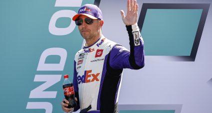 HOMESTEAD, FLORIDA - OCTOBER 23: Denny Hamlin, driver of the #11 FedEx Ground Toyota, waves to fans as he walks onstage during driver intros prior to the NASCAR Cup Series Dixie Vodka 400 at Homestead-Miami Speedway on October 23, 2022 in Homestead, Florida. (Photo by Sean Gardner/Getty Images) | Getty Images