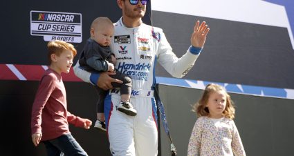 CONCORD, NORTH CAROLINA - OCTOBER 08: Kyle Larson, driver of the #5 Valvoline/HendrickCars.com Chevrolet, sons, Cooper Larson and Owen Larson and daughter Audrey Larson walk onstage during driver intros prior to the NASCAR Cup Series Bank of America ROVAL 400 at Charlotte Motor Speedway on October 08, 2023 in Concord, North Carolina. (Photo by Keenan Hairston/Getty Images) | Getty Images