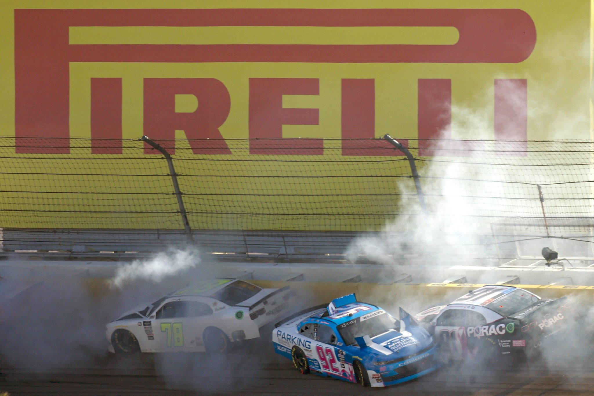 LAS VEGAS, NEVADA - OCTOBER 14: Anthony Alfredo, driver of the #78 BJ McLeod Motorsports Chevrolet, Josh Williams, driver of the #92 Parking Guidance Systems Chevrolet, and Kyle Weatherman, driver of the #91 PORAC Chevrolet, spin after an on-track incident during the NASCAR Xfinity Series Alsco Uniforms 302 at Las Vegas Motor Speedway on October 14, 2023 in Las Vegas, Nevada. (Photo by Sean Gardner/Getty Images) | Getty Images
