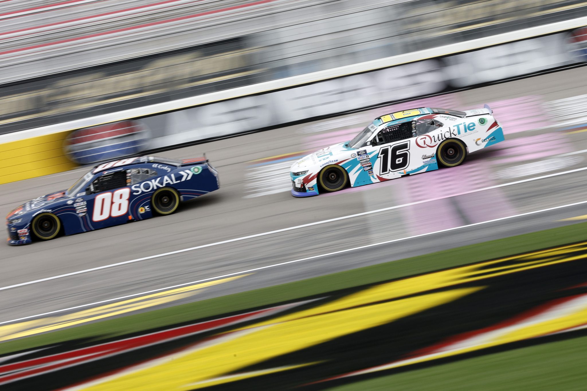 LAS VEGAS, NEVADA - OCTOBER 13: Chandler Smith, driver of the #16 Barger Precast/Quick Tie Products Inc Chevrolet, and Stefan Parsons, driver of the #08 Sokal Chevrolet, drive during practice for the NASCAR Xfinity Series Alsco Uniforms 302 at Las Vegas Motor Speedway on October 13, 2023 in Las Vegas, Nevada. (Photo by Sean Gardner/Getty Images) | Getty Images