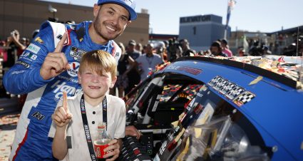 LAS VEGAS, NEVADA - OCTOBER 15: Kyle Larson, driver of the #5 HendrickCars.com Chevrolet, and son, Owen Larson pose with the winner sticker on his car in victory lane after winning the NASCAR Cup Series South Point 400 at Las Vegas Motor Speedway on October 15, 2023 in Las Vegas, Nevada. (Photo by Chris Graythen/Getty Images) | Getty Images